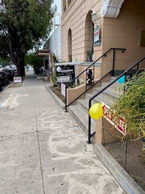 Los Angeles apartment for rent - A yellow balloon is tied to a sign on a staircase.