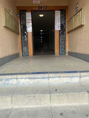 Los Angeles apartment for rent - A set of stairs leading to a door with a sign above it that reads 24/7.