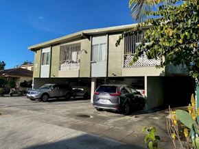 Los Angeles apartment for rent - A car is parked in front of a building.