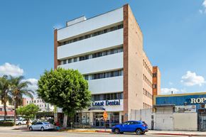 Los Angeles apartment for rent - A multi-story building with a dental office on the ground floor.