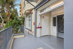 Los Angeles apartment for rent - A balcony with a metal railing and a red rope tied to a post.