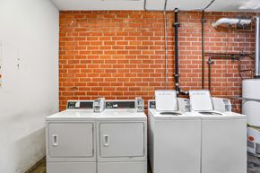 Los Angeles apartment for rent - Three white electrical boxes are on a brick wall.
