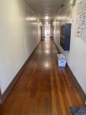 Los Angeles apartment for rent - A long hallway with a wooden floor and white walls.