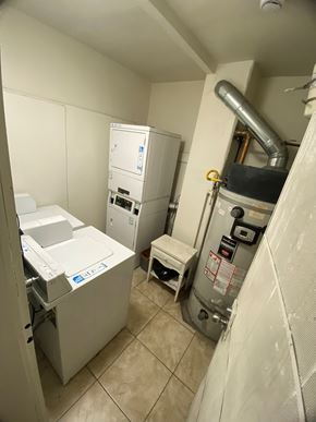 Los Angeles apartment for rent - A clean, white-walled bathroom with a washer and dryer.