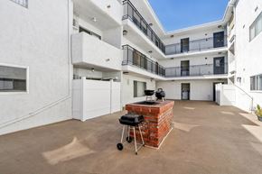 Los Angeles apartment for rent - A patio with a BBQ grill in the middle of it.