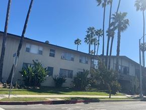 Los Angeles apartment for rent - A building with a white facade and a green lawn in front.