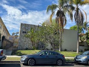Los Angeles apartment for rent - A grey car is parked on the side of a street.