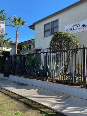 Los Angeles apartment for rent - A house with a sign that says "NOW LEASING" and a phone number.