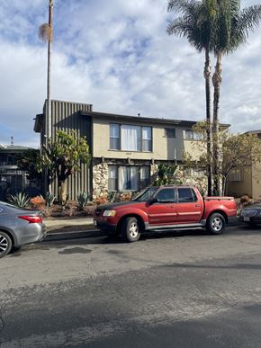 Los Angeles apartment for rent - A red pickup truck is parked in front of a house.