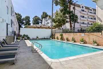 Los Angeles apartment for rent - A small pool surrounded by a concrete floor and a metal fence.