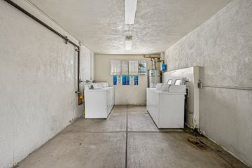 Los Angeles apartment for rent - A clean, empty industrial space with white walls and a concrete floor.