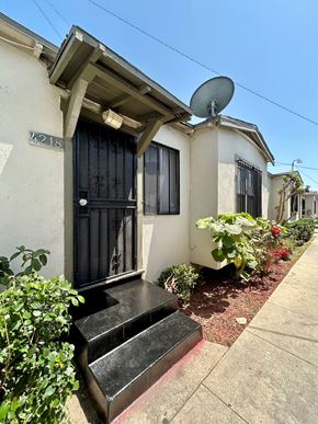 Los Angeles apartment for rent - A house numbered 218 has a black door and windows.
