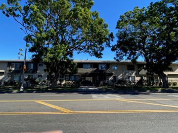 Los Angeles apartment for rent - A street view with a crosswalk and a building in the background.