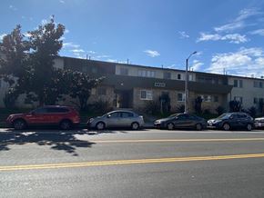 Los Angeles apartment for rent - A red car is parked on the left side of the street.