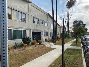 Los Angeles apartment for rent - A building with a green awning and a white door.