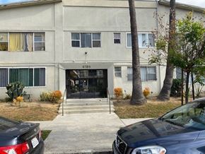 Los Angeles apartment for rent - A black car is parked in front of a building with the number 4709 on it.