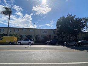 Los Angeles apartment for rent - A yellow van is parked in front of a building.