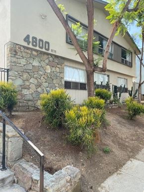 Los Angeles apartment for rent - A house numbered 4800 with a stone wall and a tree in front.