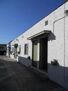 Los Angeles apartment for rent - A white building with a green door and windows.