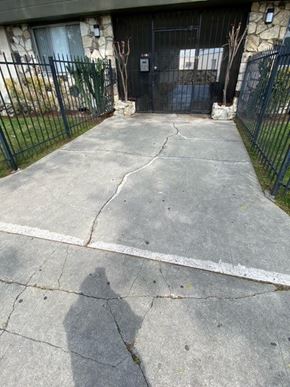 Los Angeles apartment for rent - A black gate is in front of a house.