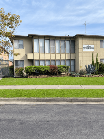 Los Angeles apartment for rent - A building with a sign that says "NOW LEASING" on it.