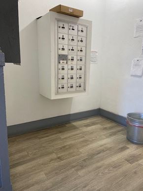 Los Angeles apartment for rent - A metal bucket is on the floor next to a wall with a panel of switches.