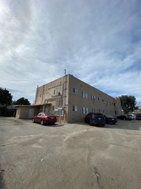 Los Angeles apartment for rent - A parking lot with a building and cars.