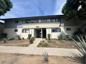 Los Angeles apartment for rent - A building with a white facade and a small garden in front.