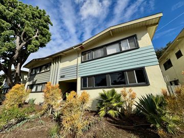 Los Angeles apartment for rent - A house with a blue and beige exterior is surrounded by greenery.