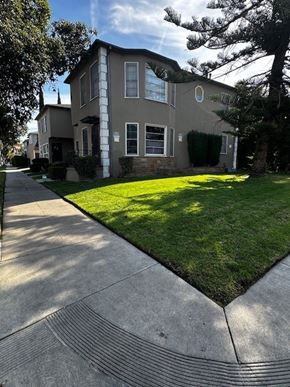 Los Angeles apartment for rent - A house with a well-kept lawn and a sidewalk in front.