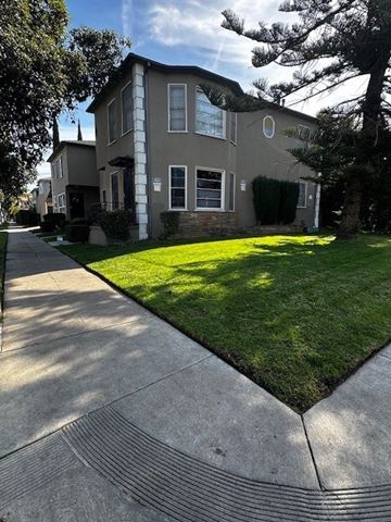 Los Angeles apartment for rent - A house with a well-kept lawn and a sidewalk in front.