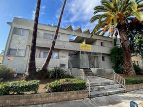 Los Angeles apartment for rent - A building with a "Now Leasing" sign in front of it.