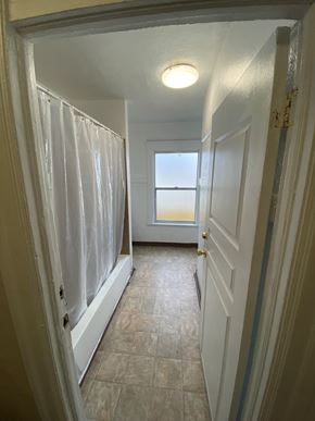 Los Angeles apartment for rent - A hallway with a door on the right and a window on the left.