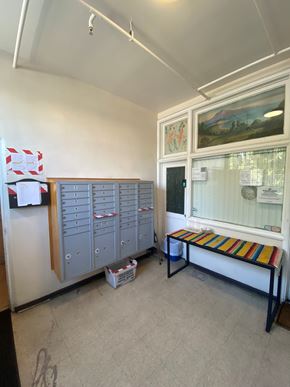Los Angeles apartment for rent - A room with a bench, a fridge, and a cabinet.