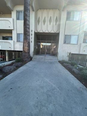 Los Angeles apartment for rent - A concrete pathway leads to a building entrance.