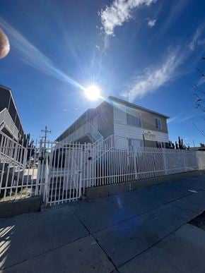 Los Angeles apartment for rent - A house with a white fence is bathed in sunlight.