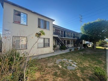 Van Nuys apartment for rent - A building with a balcony and a tree in front.