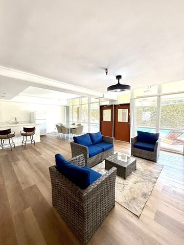 Santa Monica apartment for rent - A living room with a blue couch and a glass door.