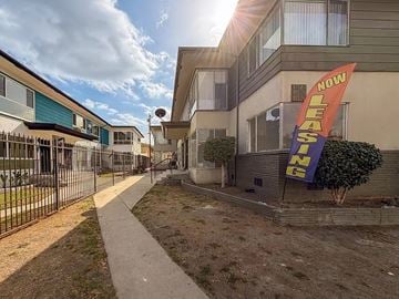 Los Angeles apartment for rent - A leasing sign is displayed in front of a building.
