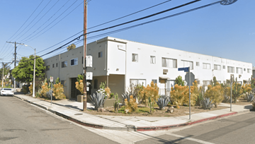 Los Angeles apartment for rent - A white building with a red line on the sidewalk in front of it.