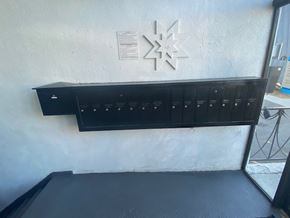 Los Angeles apartment for rent - A black shelf with several compartments is mounted on a white wall.