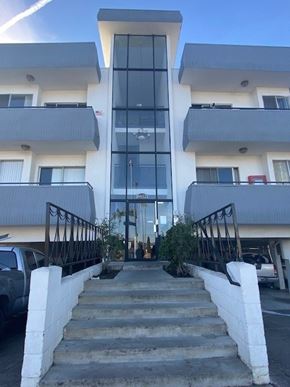 Los Angeles apartment for rent - A modern building with a glass entrance and white walls.