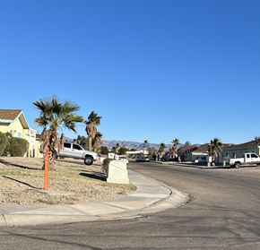 Fort Mohave apartment for rent - A residential street with houses and parked cars.