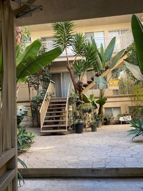 Los Angeles apartment for rent - A courtyard with a staircase and a tree.