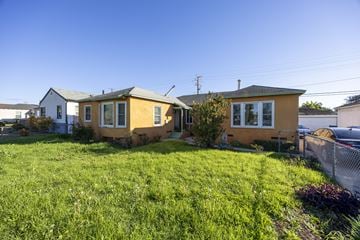 Los Angeles triplex for rent - Two houses with a green lawn in front.