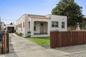 Los Angeles triplex for rent - A white house with a brown fence in front.