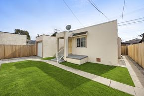 Los Angeles triplex for rent - A small house with a green lawn in front.