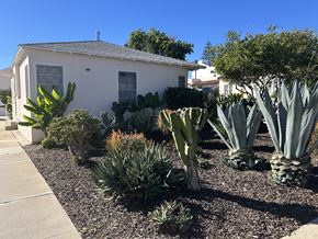 Los Angeles apartment for rent - A white house with a garden in front.