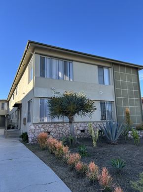 Los Angeles apartment for rent - A house with a stone wall and a cactus garden in front.