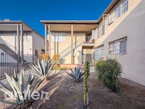 Los Angeles apartment for rent - A sunny day at a residential area with houses and cacti.